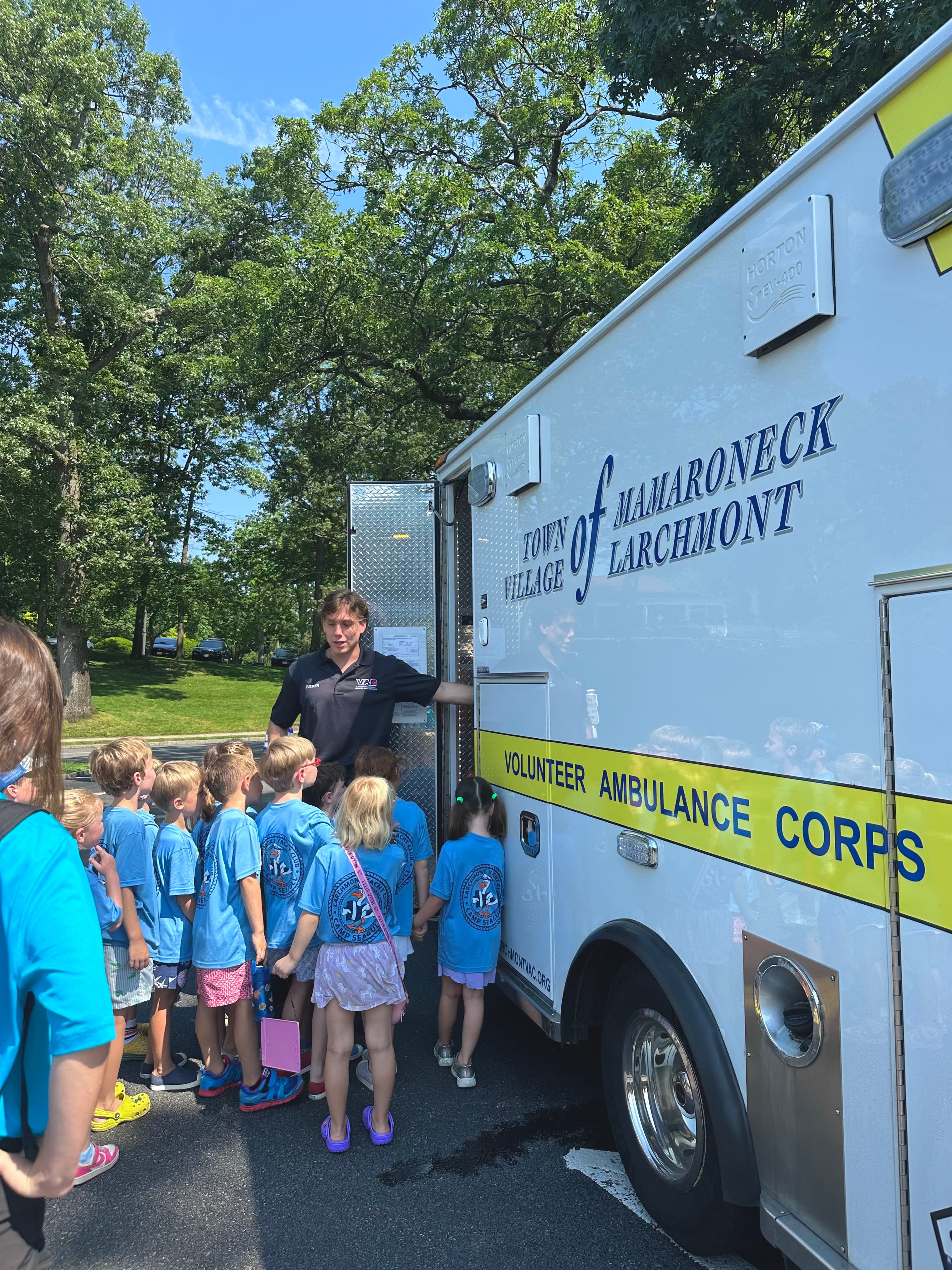 An LVAC member showing children the inside of an ambulance