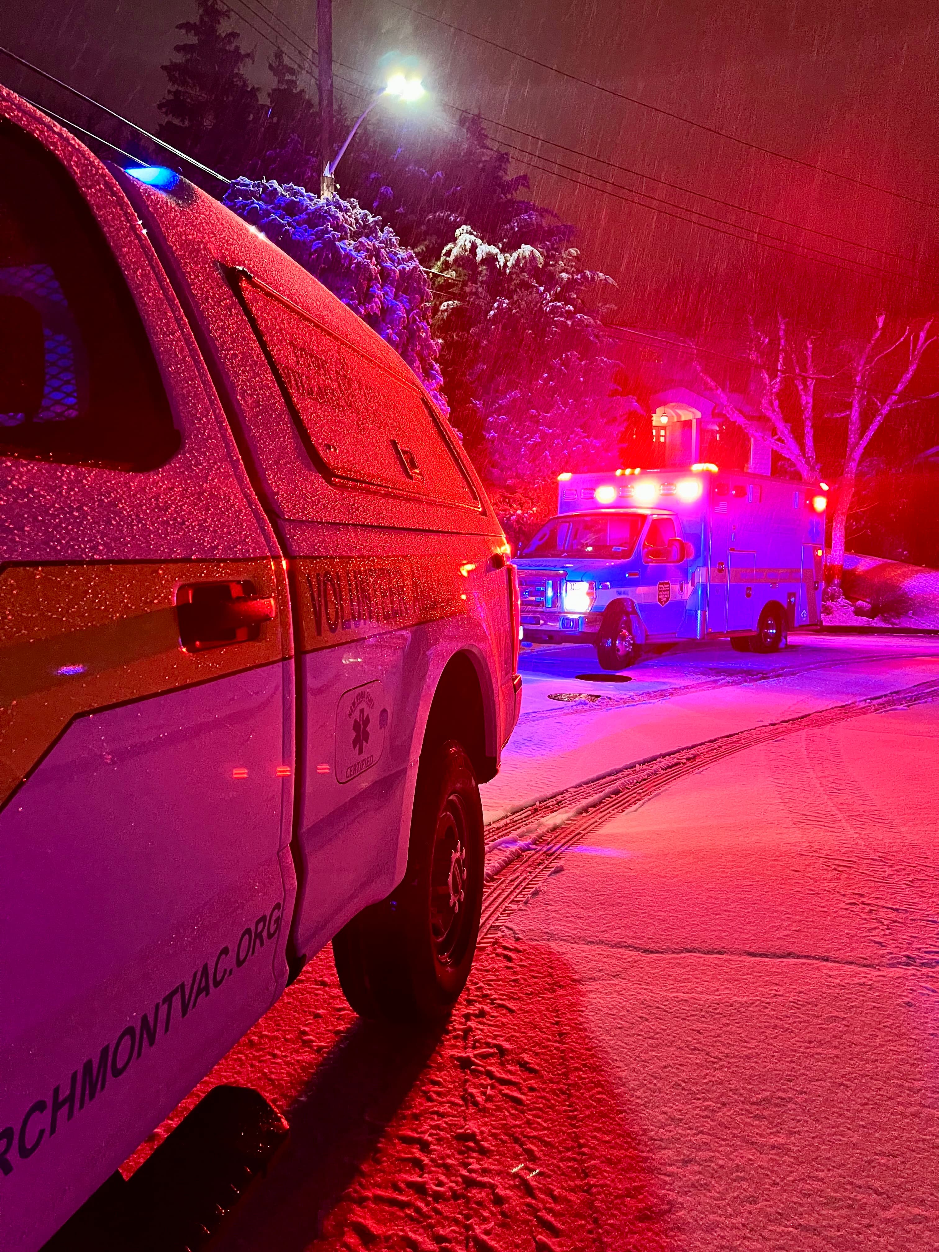 Larchmont VAC ambulance on a snowy night call with red emergency lights